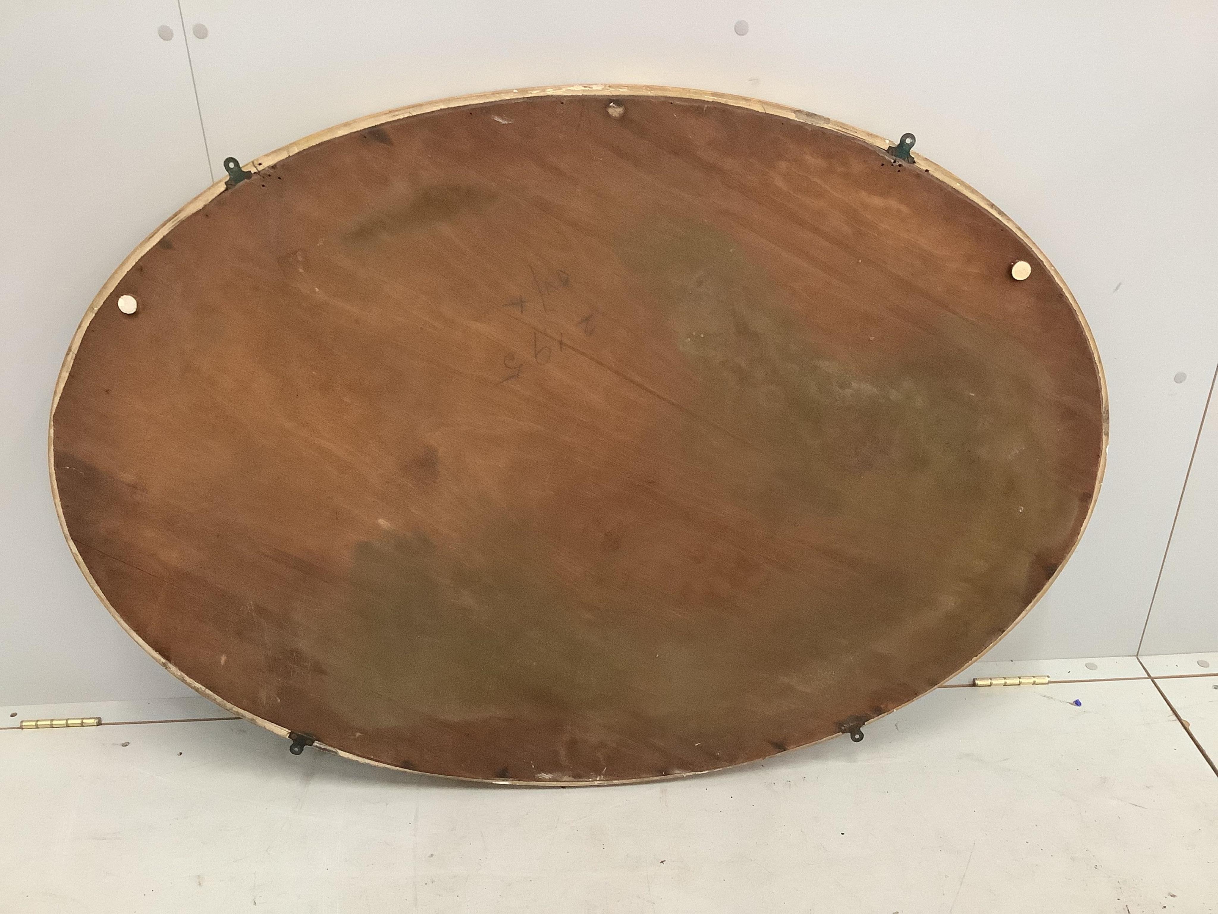 A Sheraton style oval marginal plate wall mirror, width 85cm, height 124cm. Condition - good
